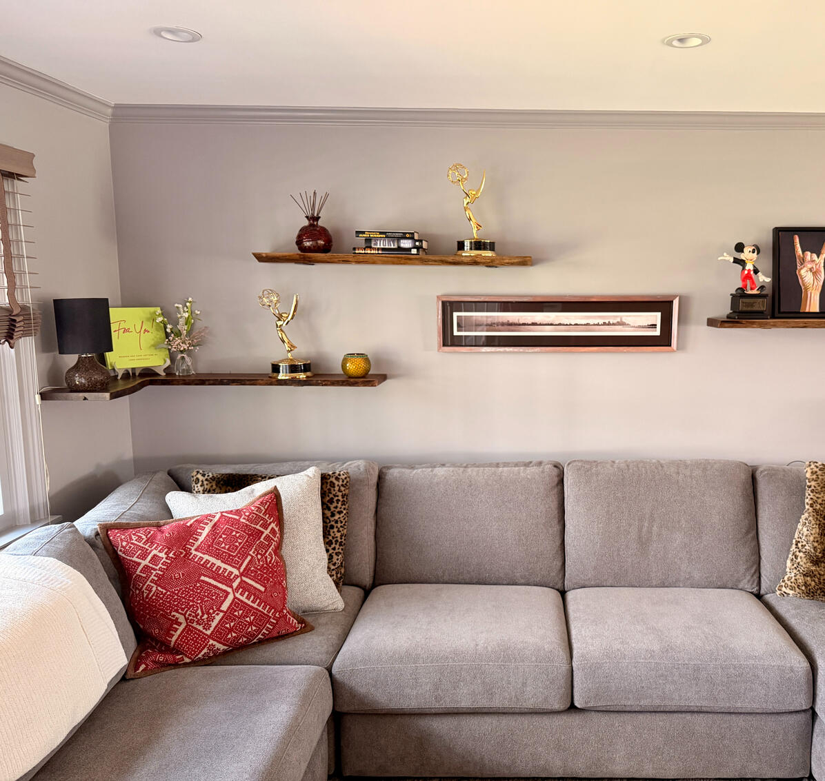 Walnut shelves above a couch Walnut shelves above a couch