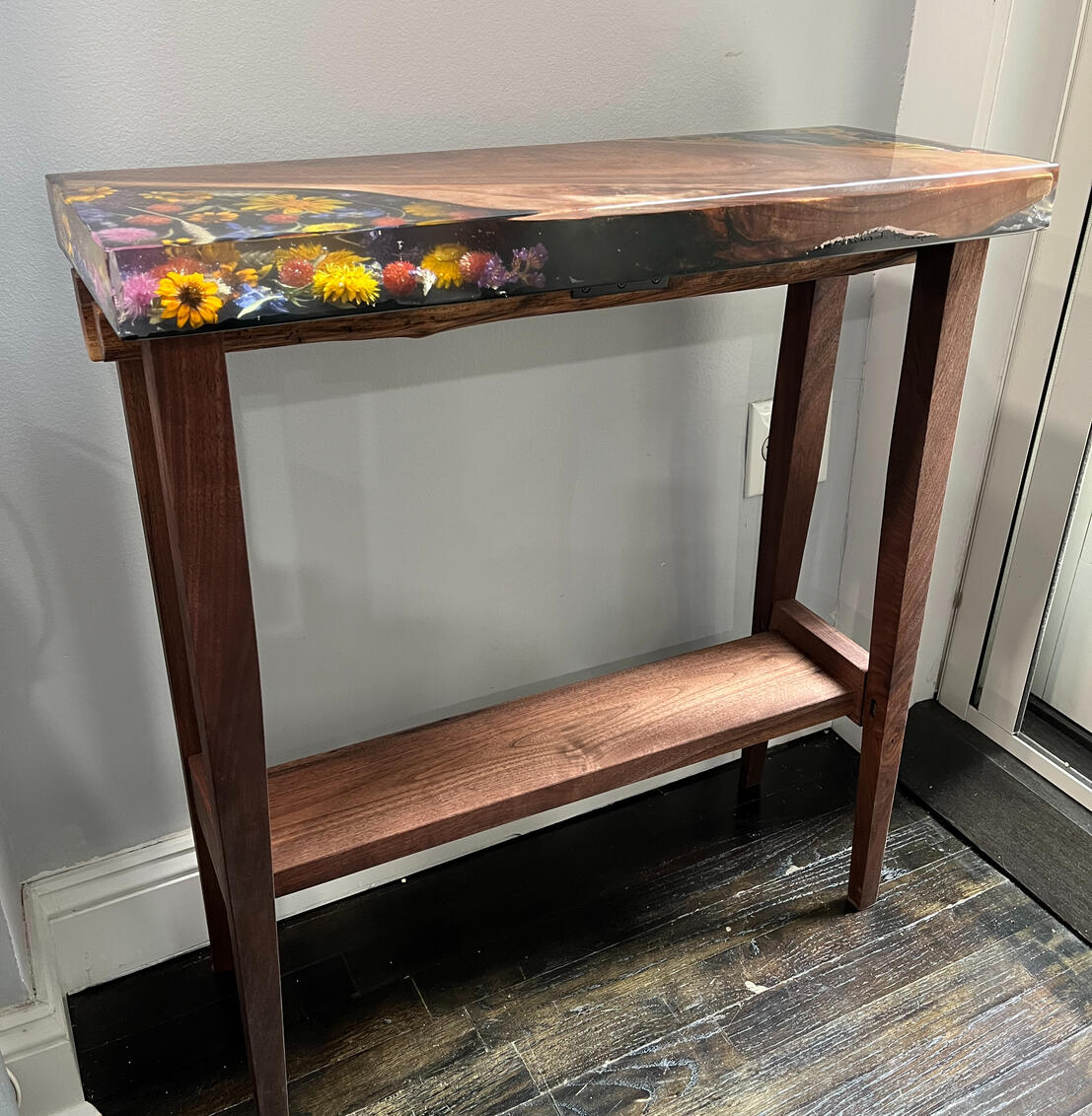 Black walnut console table with preserved flowers Black walnut console table with preserved flowers